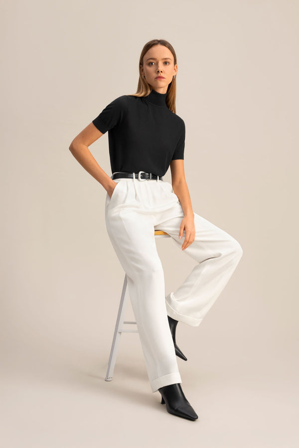 Ivory Pleated Wide-Leg Trousers - styled seated